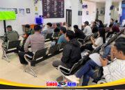 Pemohon SIM bersama petugas mengikuti nobar Piala Dunia 2026 di ruang tunggu Satpas Colombo Surabaya.