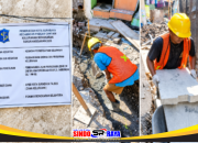 Papan informasi proyek dan pekerja melakukan perbaikan drainase Sambongan Gang 1 di Kelurahan Bongkaran, Surabaya.